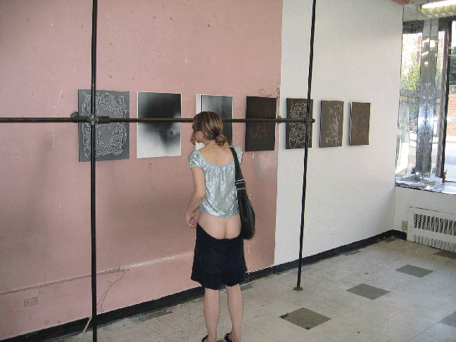 image of woman viewing art with skirt down