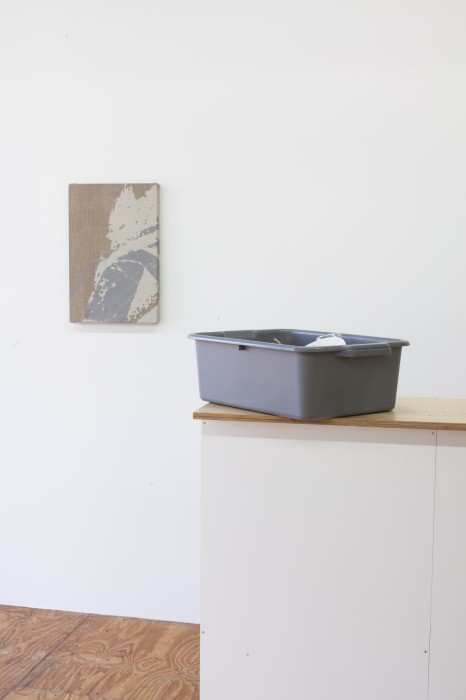installation image of painting with dishwashing bucket in foreground