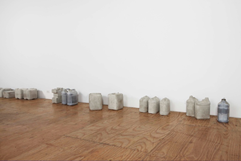 concrete molds of canisters against the wall