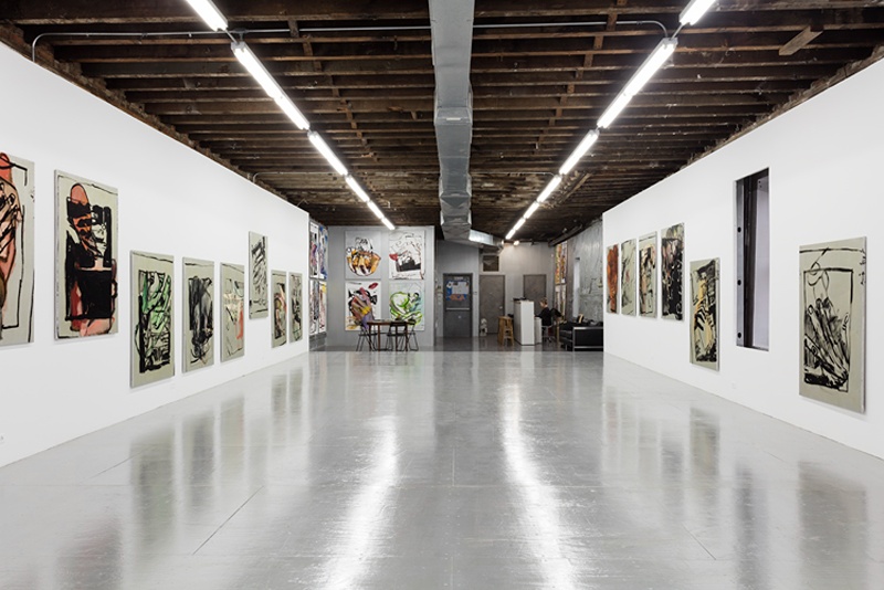 installation view of paintings of hands