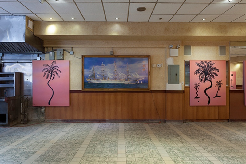 paintings of palm trees on red-pink backgrounds in a vacated Chinese restaurant